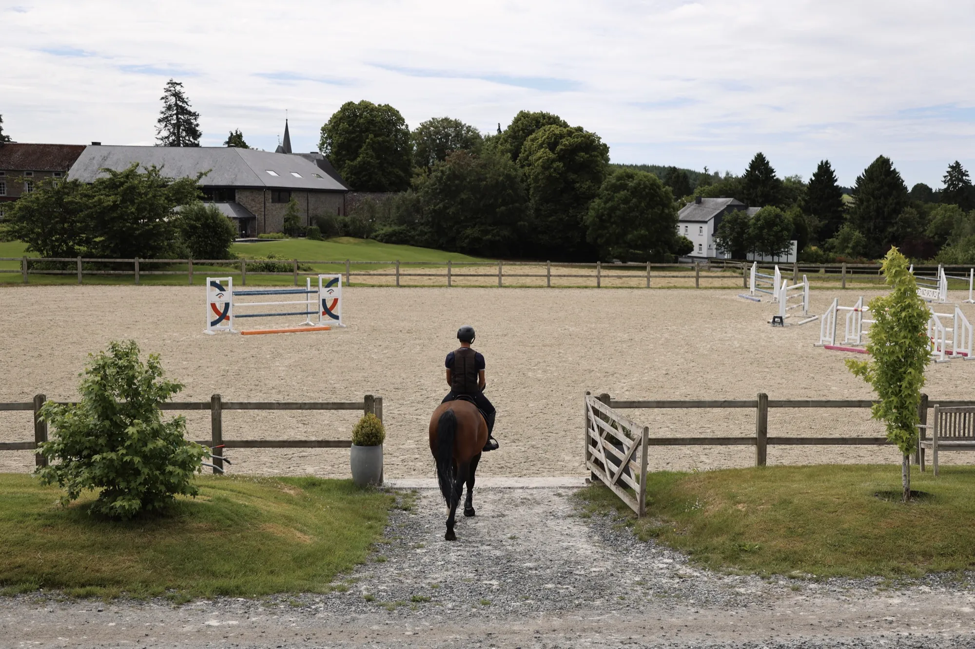 A rider entering the outdoor arena