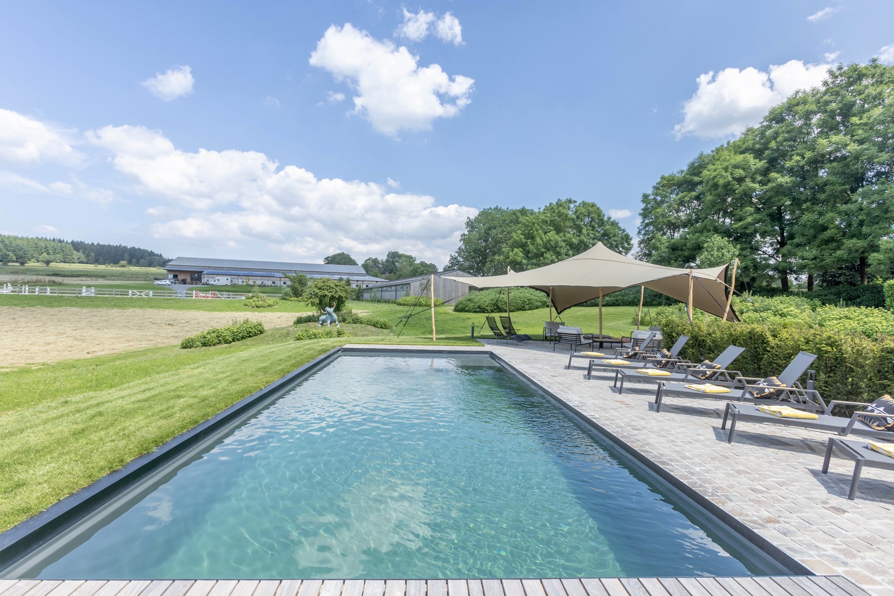 Outdoor pool and terrace facing the countryside